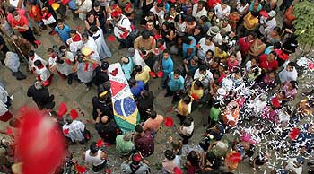 The coffin of Brazilian Jean Charles de Menezes is carried by relatives and friends