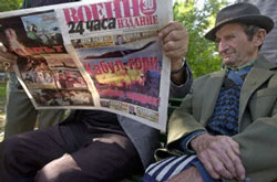 Men in downtown Sofia, Bulgaria read a special edition of Bulgarian newspaper 24 Tchasa on Oct. 8, 2001. The headlines read 'Kabul Burns' and 'Sofia on Alert'